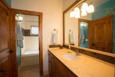 a bathroom with a sink and a mirror at Look Out Lodge - On North Shore w Lake View, Hot Tub, Pool Table and Pet Friendly in Kings Beach