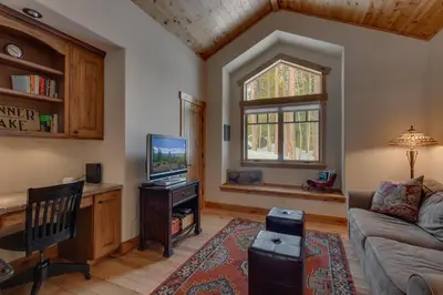 a living room with a couch and a tv at Majestic Woods at Tahoe Donner - High End Craftsman w Game Room, Hot Tub, Amenity Access in Truckee