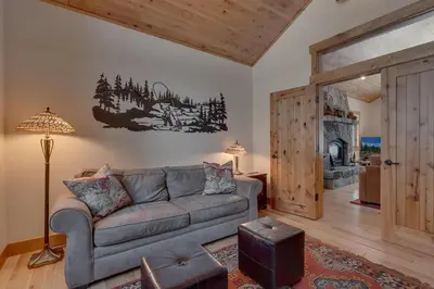 a living room with a couch and a fireplace at Majestic Woods at Tahoe Donner - High End Craftsman w Game Room, Hot Tub, Amenity Access in Truckee