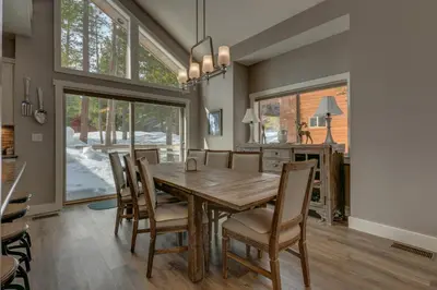 a dining room with a wooden table and chairs at Mountain Jewel in Tahoe Donner - Beautiful 4 Bedroom w Hot tub, Access to HOA Amenities in Truckee