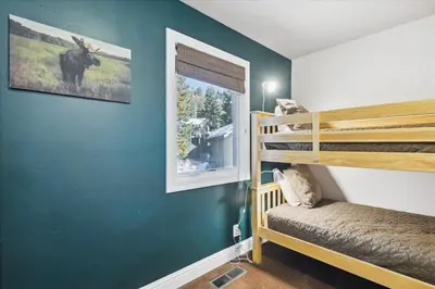 a room with two bunk beds and a window at On the Edge at Alpine Meadows - Fireplace- Mountain Views- Great Location! Shuttle Service! in Olympic Valley