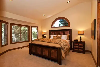 a bedroom with a large bed and a window at Rooney Ridge - Luxury 2600 Sq Ft, Cozy Fireplace, Family Room, Ping Pong Table! in Carnelian Bay