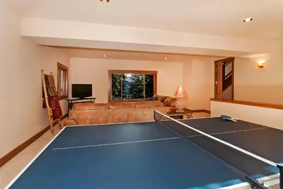 a living room with a ping pong table at Rooney Ridge - Luxury 2600 Sq Ft, Cozy Fireplace, Family Room, Ping Pong Table! in Carnelian Bay