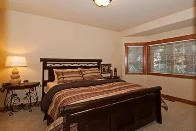 a bedroom with a large bed and a window at Rooney Ridge - Luxury 2600 Sq Ft, Cozy Fireplace, Family Room, Ping Pong Table! in Carnelian Bay