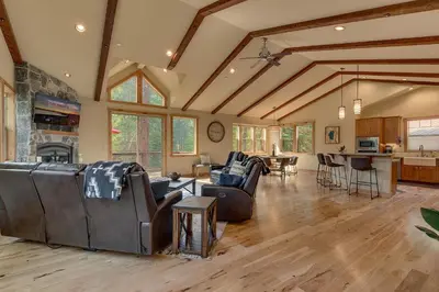 a large living room with couches and a kitchen at Paradise in the Pines - Luxury Home in Quite Neighborhood, Wooded Views, Short Drive to Skiing in Carnelian Bay