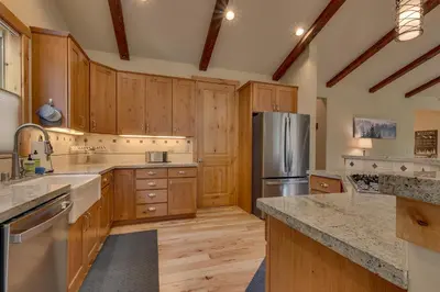 a kitchen with wooden cabinets and a stainless steel refrigerator at Paradise in the Pines - Luxury Home in Quite Neighborhood, Wooded Views, Short Drive to Skiing in Carnelian Bay