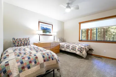 a bedroom with two beds and a window at Shady Pines at Tahoe Donner- Serene Forest Retreat, 2 Gas Fireplaces, Sauna in Truckee