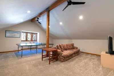 a living room with a couch and a table at Shady Pines at Tahoe Donner- Serene Forest Retreat, 2 Gas Fireplaces, Sauna in Truckee