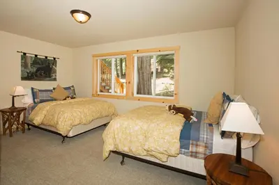 a bedroom with two beds and a window at Sans Souci Terrace on the West Shore- 4 BR Cabin, Avail as a Ski Lease, Near Skiing! in Homewood
