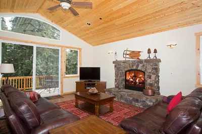a living room with a couch and a fireplace at Sans Souci Terrace on the West Shore- 4 BR Cabin, Avail as a Ski Lease, Near Skiing! in Homewood