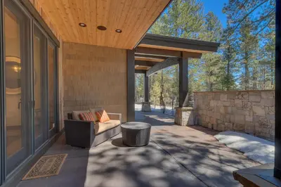 a porch of a house with a couch on a patio at Sage Hen at Grays Crossing - Gorgeous 4BR 4BA Home w Private Hot Tub in Truckee