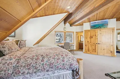 a bedroom with a bed and a wooden ceiling at Silverado Lodge at Palisades - 4BR w Private Hot Tub & Ski Shuttle in Olympic Valley