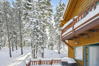 a cabin in the snow with snow covered trees at Silverado Lodge at Palisades - 4BR w Private Hot Tub & Ski Shuttle in Olympic Valley
