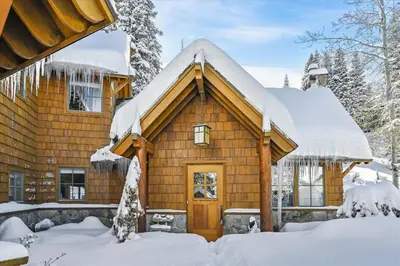 a log cabin in the snow at Silverado Lodge at Palisades - 4BR w Private Hot Tub & Ski Shuttle in Olympic Valley