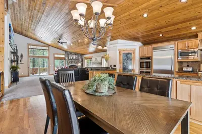 a kitchen and dining room with a wooden ceiling at Ski View at Tahoe Donner - Stunning 4 BR w Private Hot Tub - HOA Amenities in Truckee