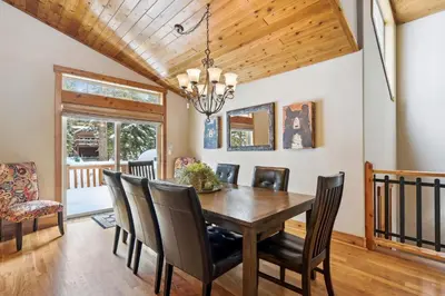 a dining room with a wooden table and chairs at Ski View at Tahoe Donner - Stunning 4 BR w Private Hot Tub - HOA Amenities in Truckee