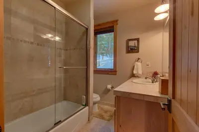 a bathroom with a shower and a toilet and a sink at Skislope Manor - Spacious Tahoe Donner 4 BR with Gorgeous Home Theater and Hot Tub in Truckee