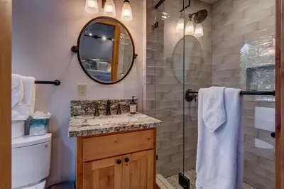 a bathroom with a sink and a shower with a mirror at Snowbird Retreat at Northstar - Beautiful 4BR with Private Hot Tub, Free Ski Shuttle, HOA Amenities in Truckee