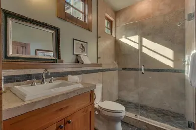 a bathroom with a sink and a toilet and a shower at Norse Hall in Tahoe Donner - Gorgeous Home with Private Hot Tub and Gourmet Kitchen in Truckee