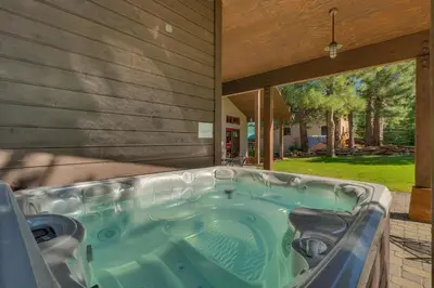 a jacuzzi tub on the side of a house at Norse Hall in Tahoe Donner - Gorgeous Home with Private Hot Tub and Gourmet Kitchen in Truckee