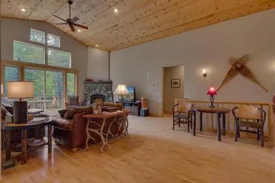 a living room with a couch and a table at High Altitude at Tahoe Donner - Huge 4 BR with Private Hot Tub, Pool Table, Ping Pong, HOA Amenities in Truckee
