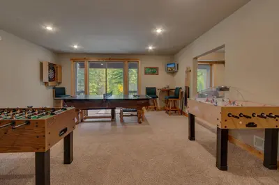a living room with two tables and a pool table at High Altitude at Tahoe Donner - Huge 4 BR with Private Hot Tub, Pool Table, Ping Pong, HOA Amenities in Truckee