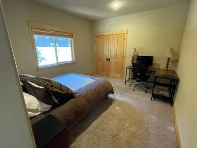 a bedroom with a bed and a desk and a television at High Altitude at Tahoe Donner - Huge 4 BR with Private Hot Tub, Pool Table, Ping Pong, HOA Amenities in Truckee