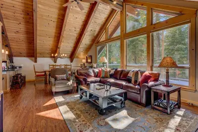 a living room with a couch and a table at Edelweiss Retreat- Close to Lake and Ski Resorts- Pet Friendly- Hot Tub in Tahoe City