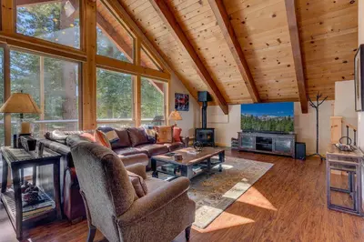 a living room with a couch and a table at Edelweiss Retreat- Close to Lake and Ski Resorts- Pet Friendly- Hot Tub in Tahoe City