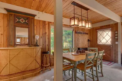 a kitchen and dining room with a table and chairs at Cozy Wood Cabin- Updated- Hot Tub- Fireplace- Backs to Forest in Carnelian Bay