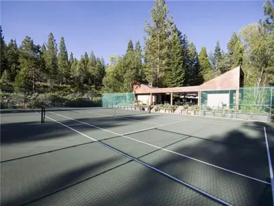 a tennis court in front of a house at North Shore Lakeside Condo #8 by Tahoe Getaways - Updated 3 Story Condo Near Palisades Resort w HOA! in Tahoe City