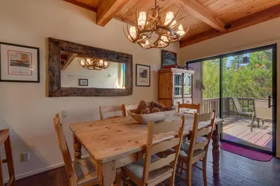 a dining room with a wooden table and a mirror at North Shore Lakeside Condo #8 by Tahoe Getaways - Updated 3 Story Condo Near Palisades Resort w HOA! in Tahoe City