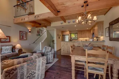 a kitchen and living room with a table and a couch at North Shore Lakeside Condo #8 by Tahoe Getaways - Updated 3 Story Condo Near Palisades Resort w HOA! in Tahoe City