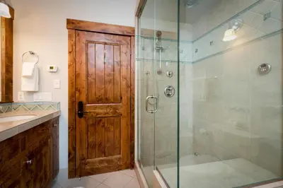 a bathroom with a shower with a glass door at North Shore Bliss by Tahoe Getaways - 3 BR plus loft & Private Hot Tub in Carnelian Bay