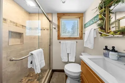 a bathroom with a shower and a toilet and a sink at Rustling Grove in Tahoe City - Pet-Friendly, Walking Distance to Downtown and Lake - Private Hot Tub in Tahoe City