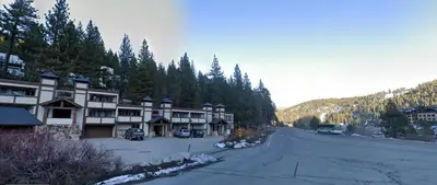 a view of a ski lodge in the mountains at Palisades Tahoe Ski Condo by Tahoe Getaways - Remodeled 2 BR, Walking Distance to Lifts & Village in Olympic Valley