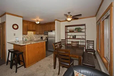 a kitchen and dining room with a table and chairs at Palisades Tahoe Ski Condo by Tahoe Getaways - Remodeled 2 BR, Walking Distance to Lifts & Village in Olympic Valley