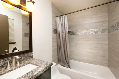 a bathroom with a tub and a sink and a shower at Pineland Chalet in Tahoe City - Classic Cabin Wood Fireplace Dog Friendly in Tahoe City