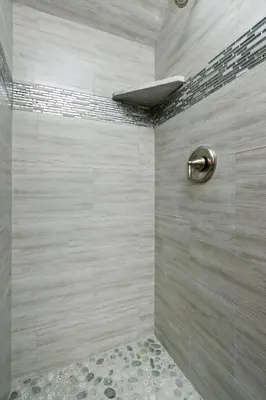 a bathroom with a shower with a stone wall at Pineland Chalet in Tahoe City - Classic Cabin Wood Fireplace Dog Friendly in Tahoe City