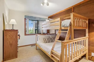 a bedroom with two bunk beds and a window at Rocky Point # 4 - 2 BR Northstar Condo, Shuttle to Slopes, HOA Amenities! in Truckee