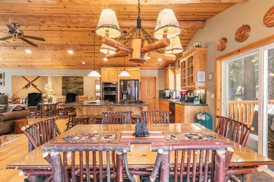 a dining room and kitchen with a table and chairs at Secret Garden Lodge - 4BR Walking Distance to the Lake, Hot Tub, Close to Ski Resorts! in Carnelian Bay