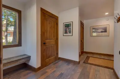 an empty hallway with a wooden door and a window at Silver Tip at Tahoe Park w HOA amenities - 3BR Pet Friendly, Hot Tub, Tahoe City in Tahoe City