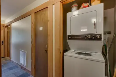 a small kitchen with a stove and a microwave at Silver Strike #2- Walk to Village- Ski Shuttle to Lifts in Truckee