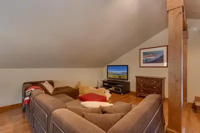 a living room with a couch and a tv at Tahoe Point of View - Amazing Lake Views at this 4BR w Hot Tub, Sauna, Near Skiing in Tahoe City