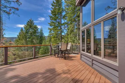 a large deck with a table and chairs on it at Tahoe Point of View - Amazing Lake Views at this 4BR w Hot Tub, Sauna, Near Skiing in Tahoe City