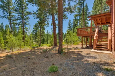 a cabin in the woods with a deck at Starlight Retreat at Gray's Crossing in Truckee