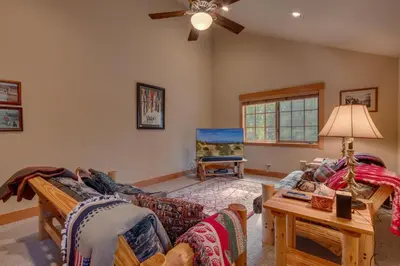 a living room with a couch and a table at Tahoe Time on North Shore - 4 BR Cabin w Private Hot Tub, Pet Friendly, Walk to Dining in Tahoe Vista