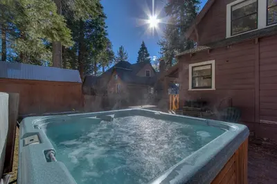 a large swimming pool in front of a house at Vanni House - Classic Tahoe Style 2 BR - Sleeps 6 - Hot Tub - Near Palisades & Downtown Tahoe City in Tahoe City