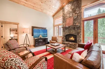 a living room with a couch and a fireplace at Truckee Timbers at Gray's Crossing by Tahoe Getaways - 4BR w Hot Tub, Ping Pong & EV in Truckee