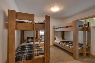 two bunk beds in a room with a bedroom at Tahoma Charm on West Shore - Beautiful Open Concept 3 BR w Private Hot Tub in Tahoma